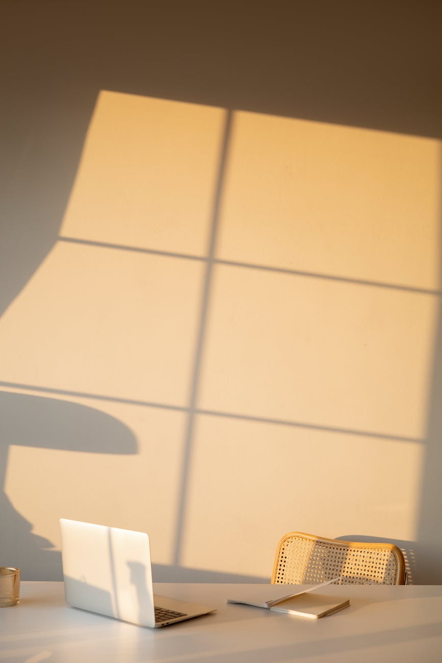 chair and table in a room with shadow of window on wall